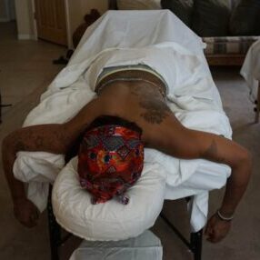 Client on a massage at an airbnb Phoenix AZ, getting a massage for her birthday